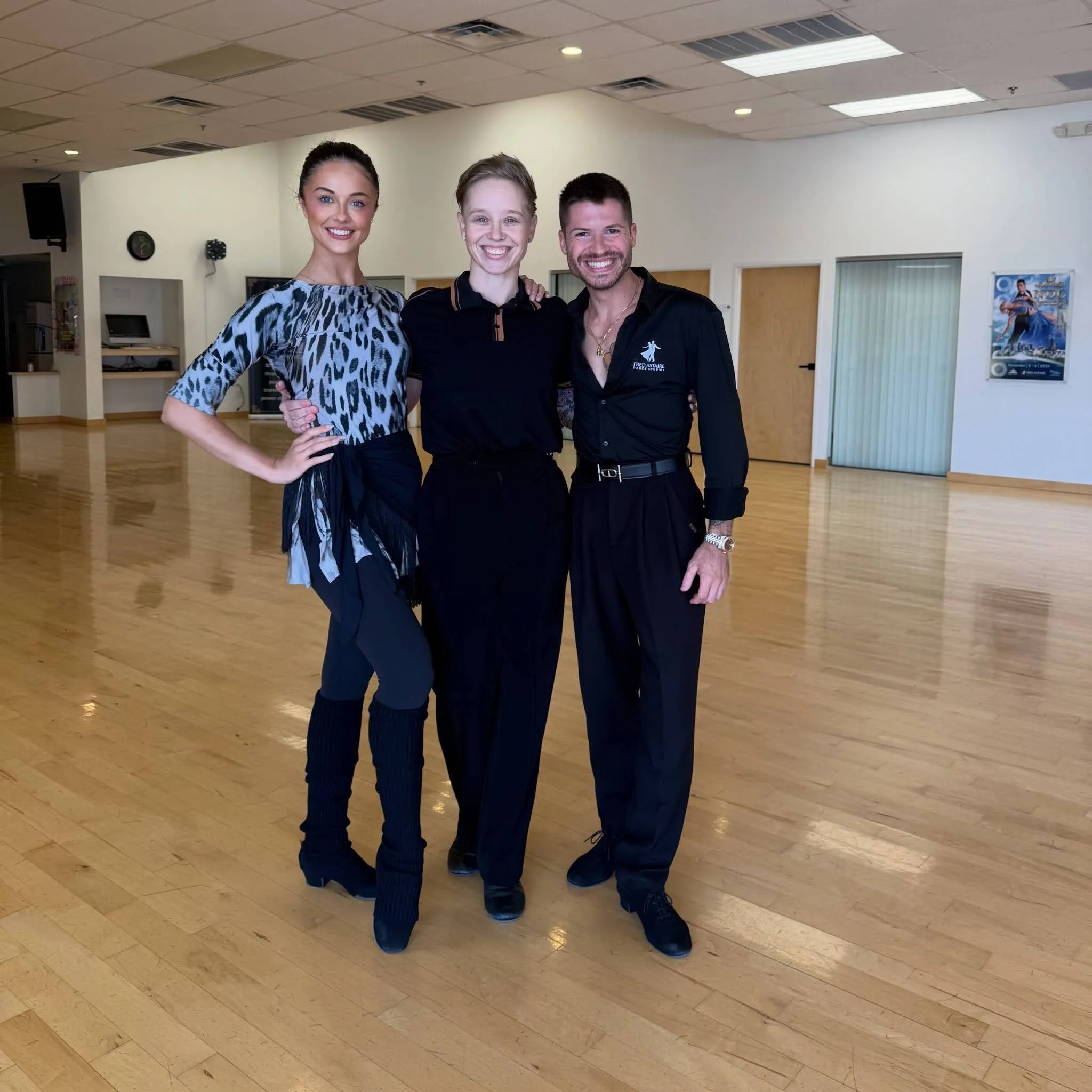 Three dancers pose together in a spacious dance studio, illustrating Is Bachata Hard To Learn with a focus on beginner-friendly bachata dance instruction and practice.