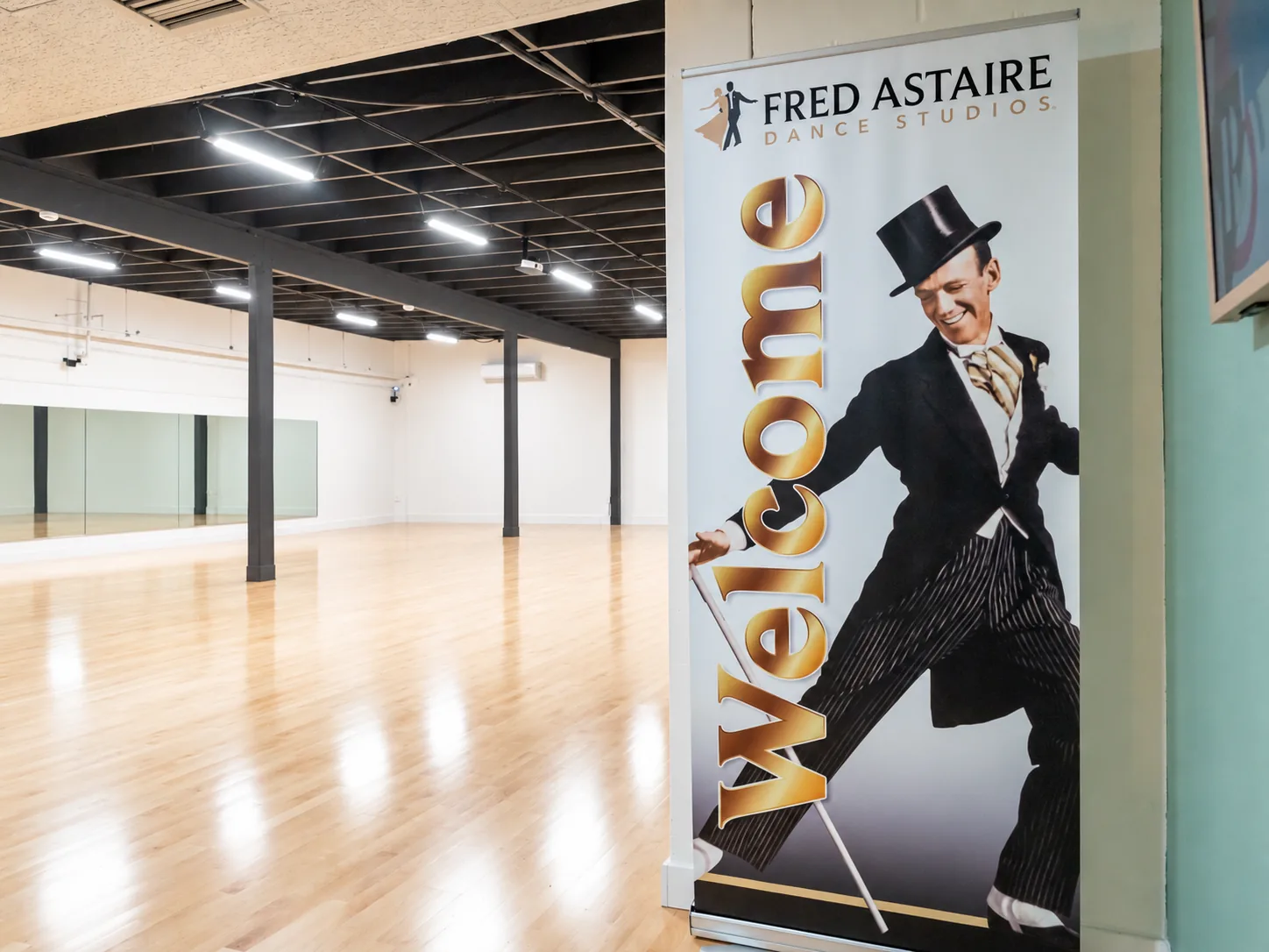 Bright ballroom dance floor with wall mirrors inside the Alhambra dance studio in Alhambra