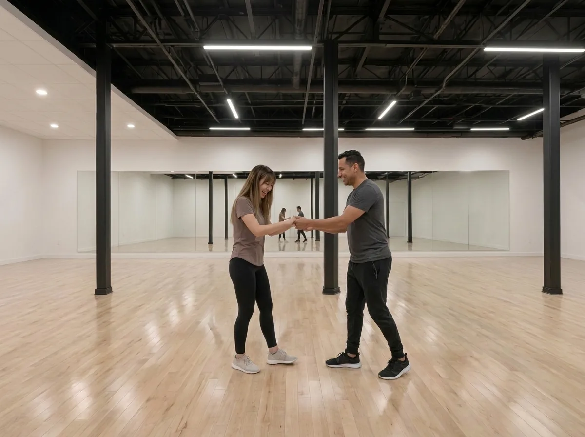 Beginner learning bachata basics with an instructor in an Alhambra studio