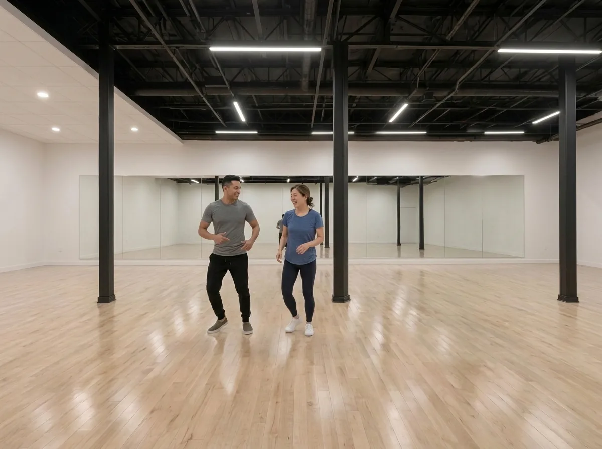 Instructor demonstrating bachata technique to a student in an Alhambra studio