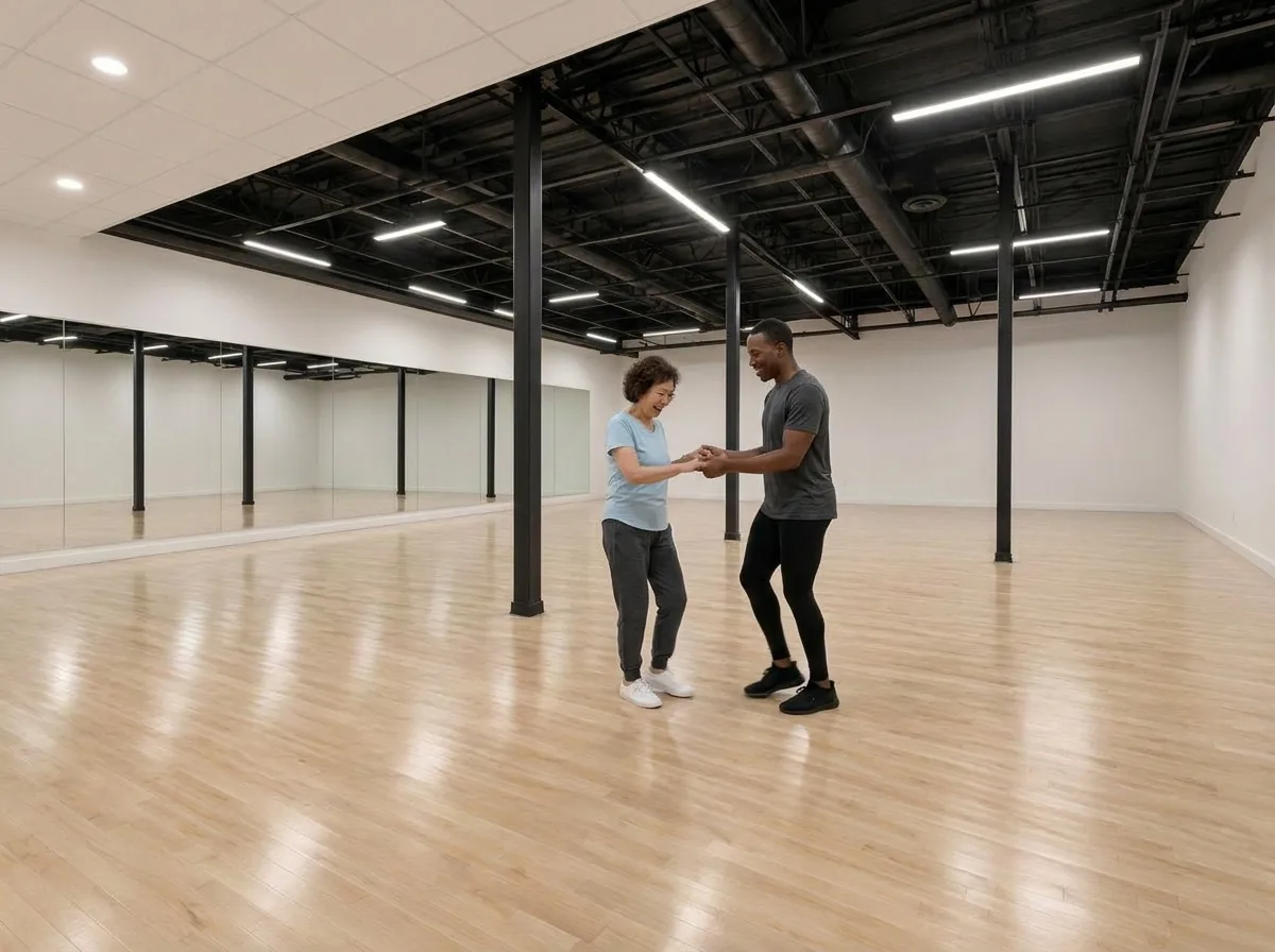 Instructor guiding a first-time student through the cha cha basic step in Alhambra