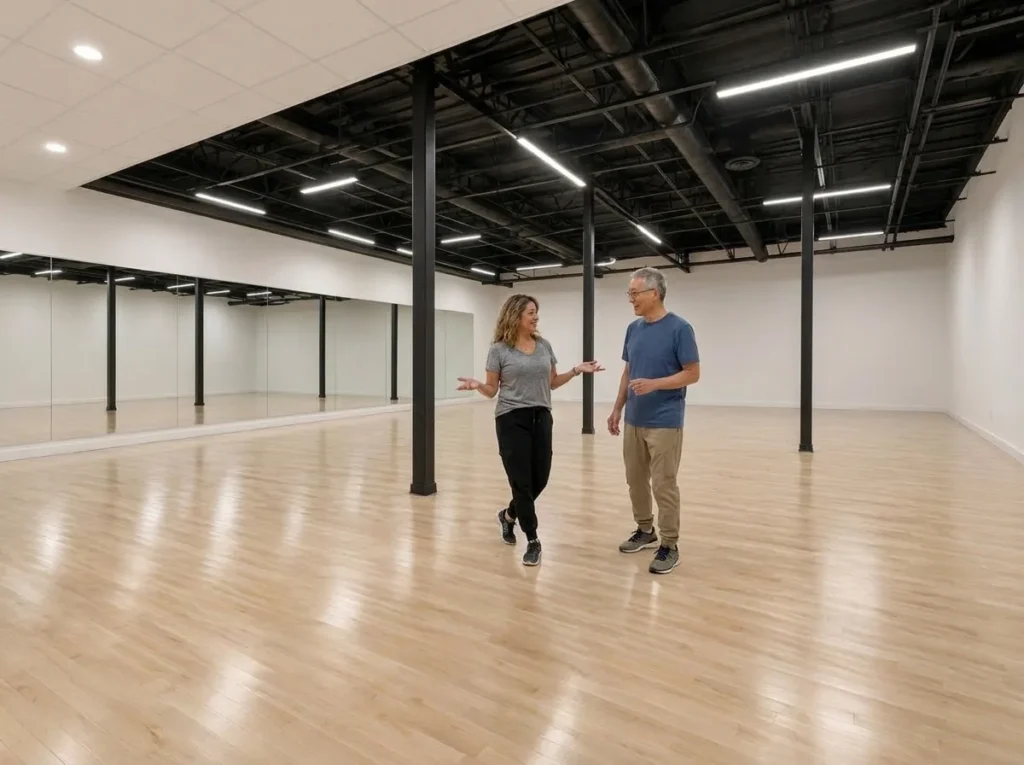 Instructor helping students choose a style during dance lessons Alhambra adults take