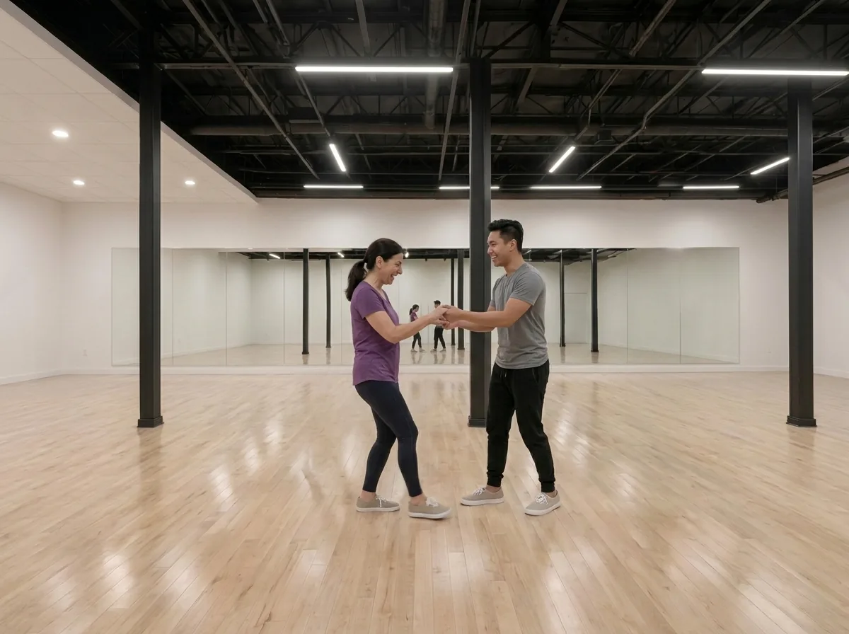 Beginner learning hustle basics with an instructor in an Alhambra dance studio