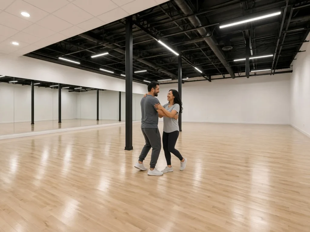 Couple moving together through a Latin dance in the studio