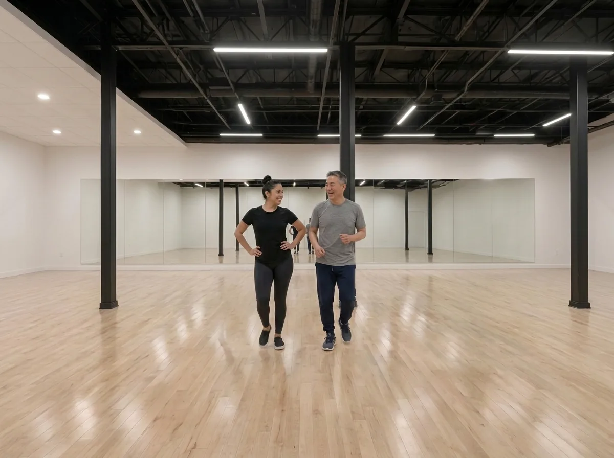 Instructor demonstrating merengue turn technique to a student in Alhambra
