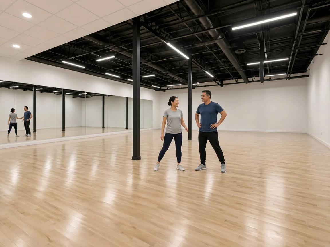 Instructor demonstrating nightclub two step technique to a student in an Alhambra studio
