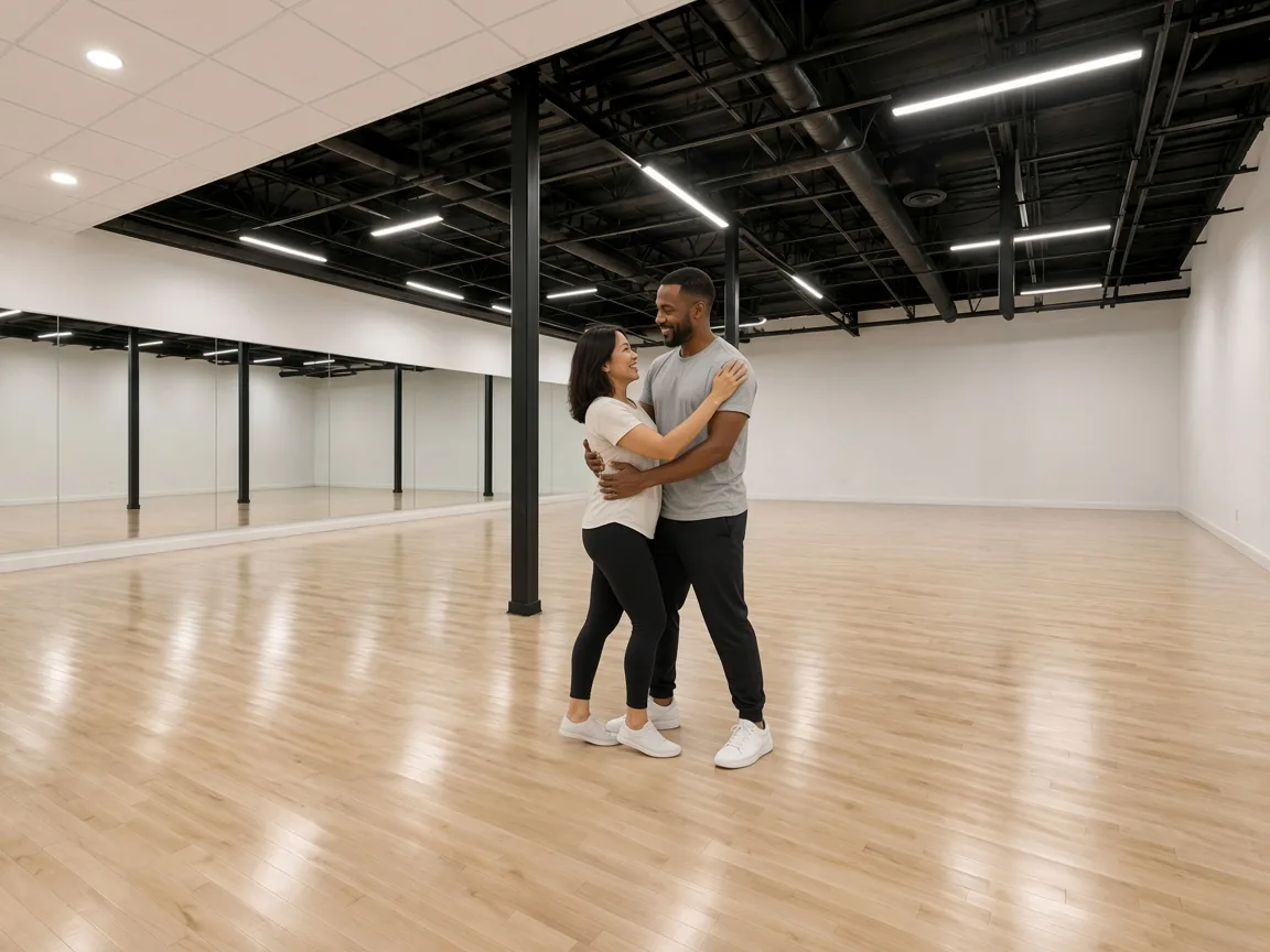 Instructor guiding a student through a private ballroom lesson