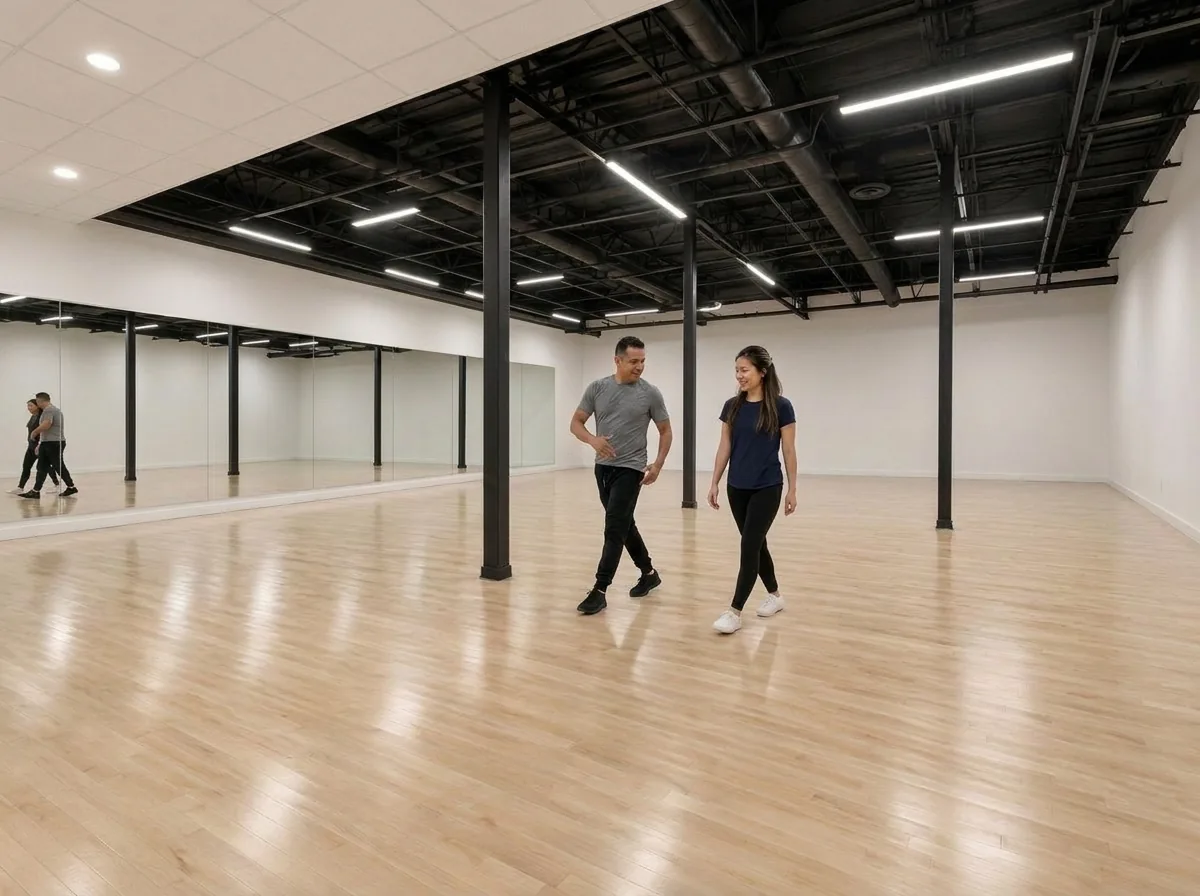 Instructor demonstrating rumba technique to a student in Alhambra
