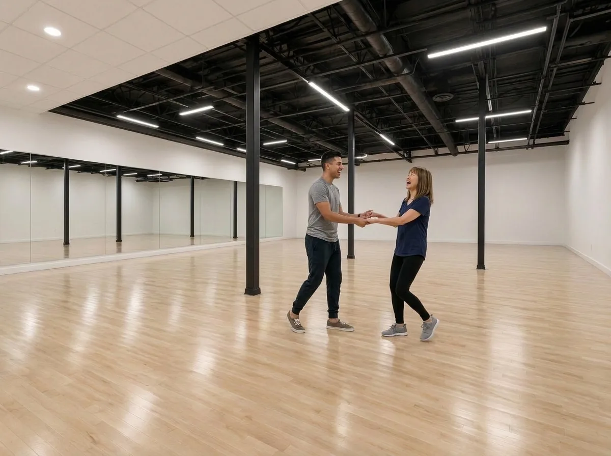 Beginner learning salsa basics with an instructor in an Alhambra dance studio