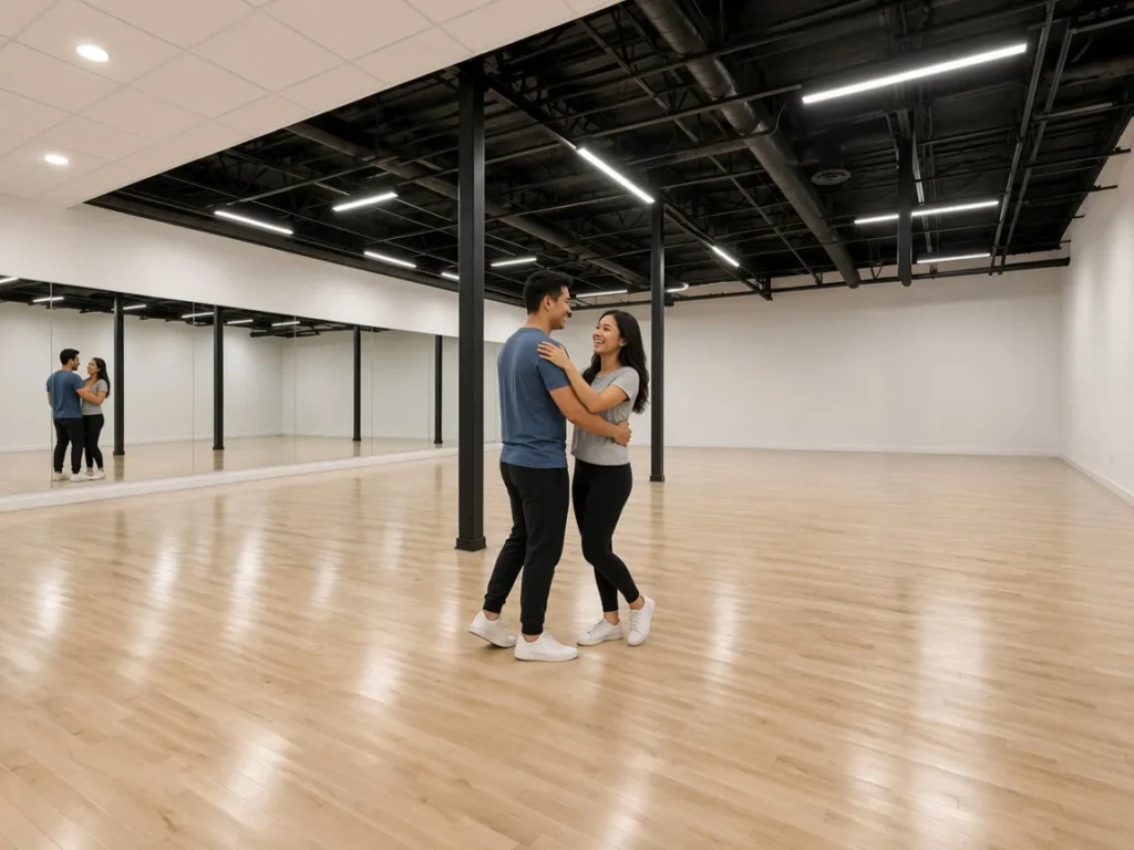 Engaged couple in first dance lessons Alhambra, practicing a simple routine together
