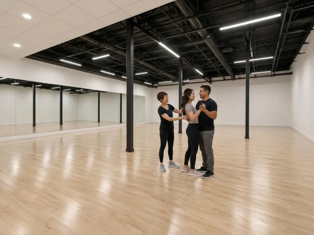 Engaged couple practicing their first dance with an instructor