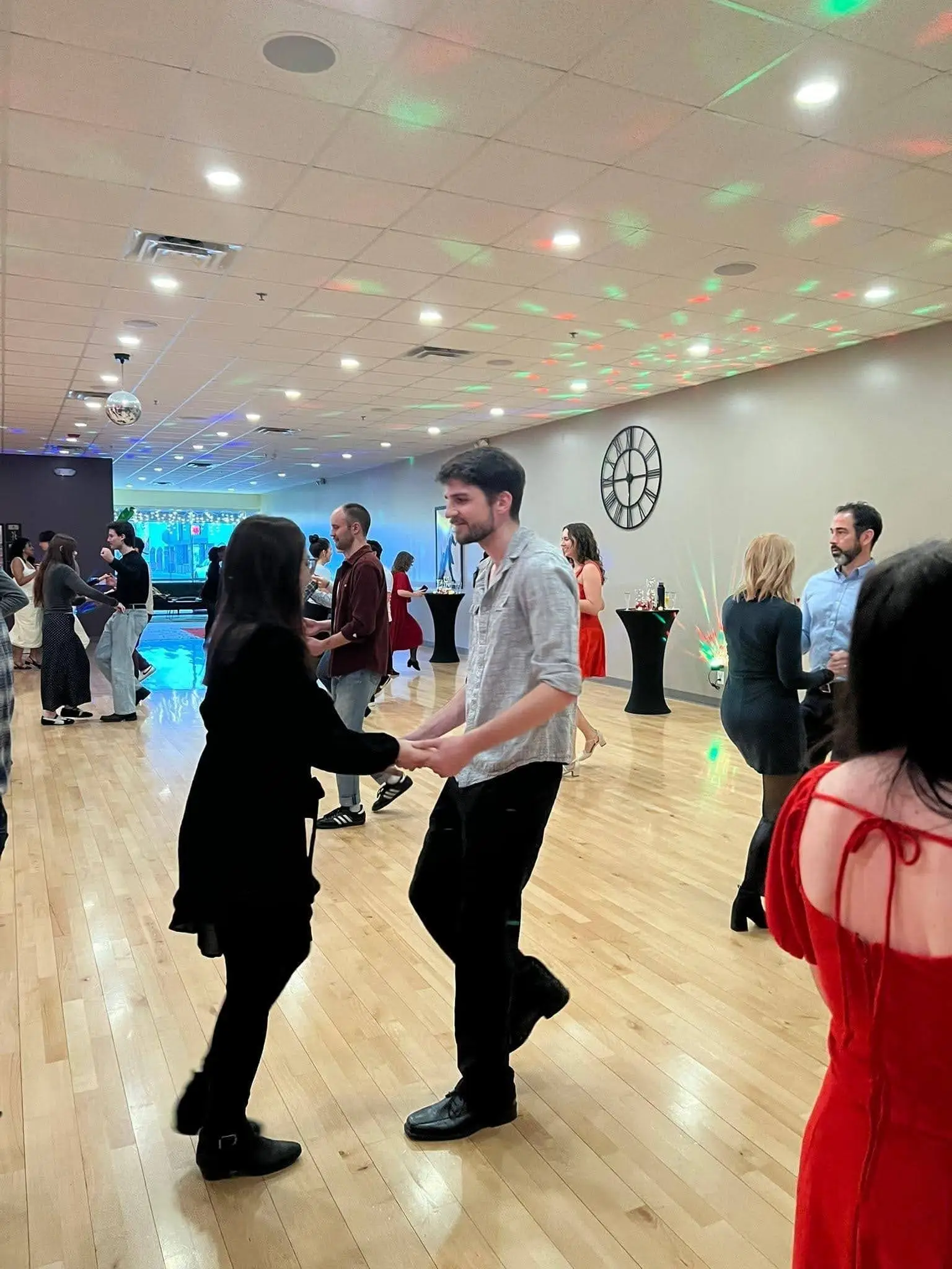 Couple dancing together during a social evening at Fred Astaire Dance Studios in Ann Arbor, MI
