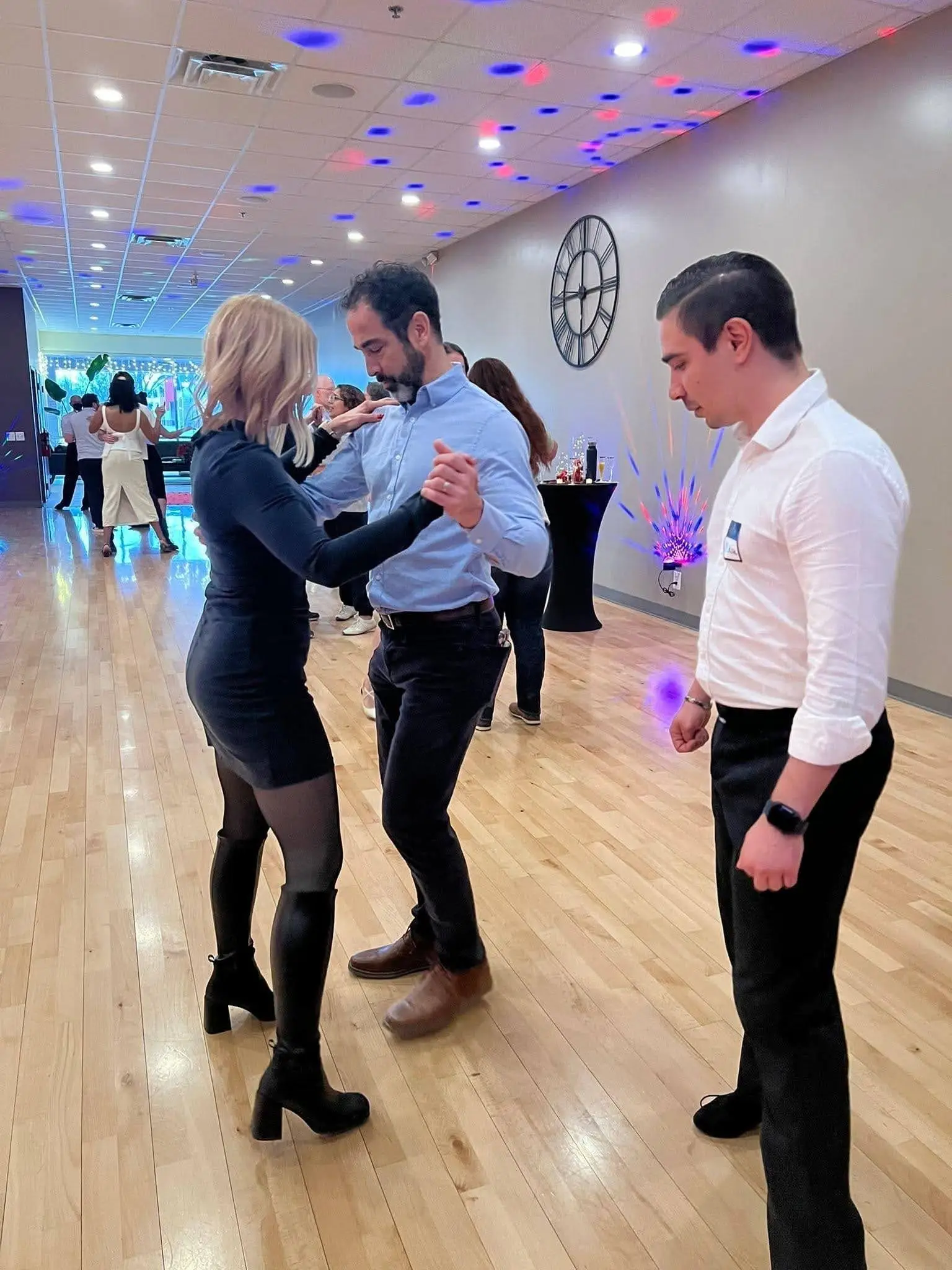 Instructor watching a couple's footwork up close at Fred Astaire Dance Studios in Ann Arbor, MI