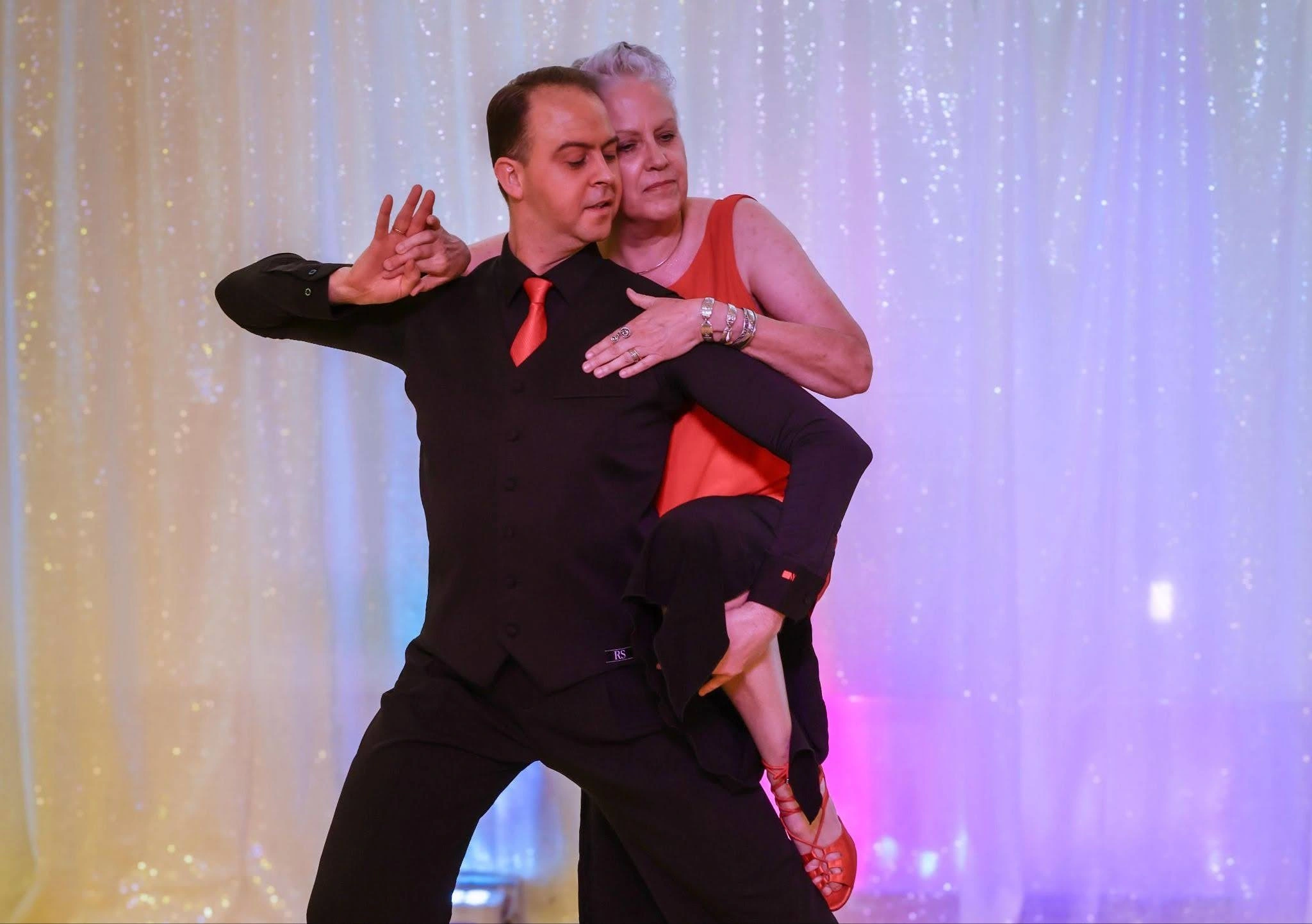 An elderly couple highlighting their signature pose that they've learned while attending Adult Dance Lessons in Washington.