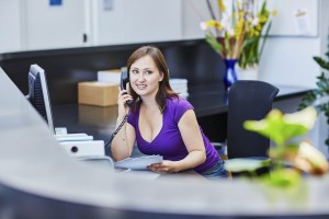Beautiful young receptionist at work