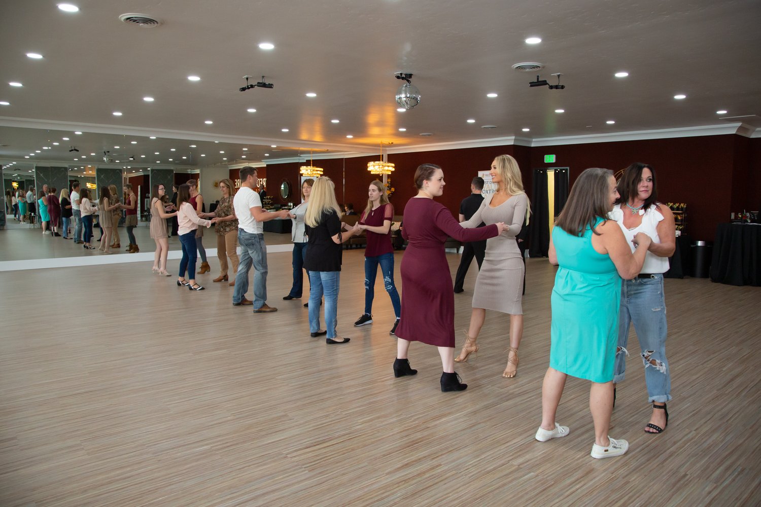 Boise residents meeting and dancing with new people at a social dancing class at the Fred Astaire dance studio.
