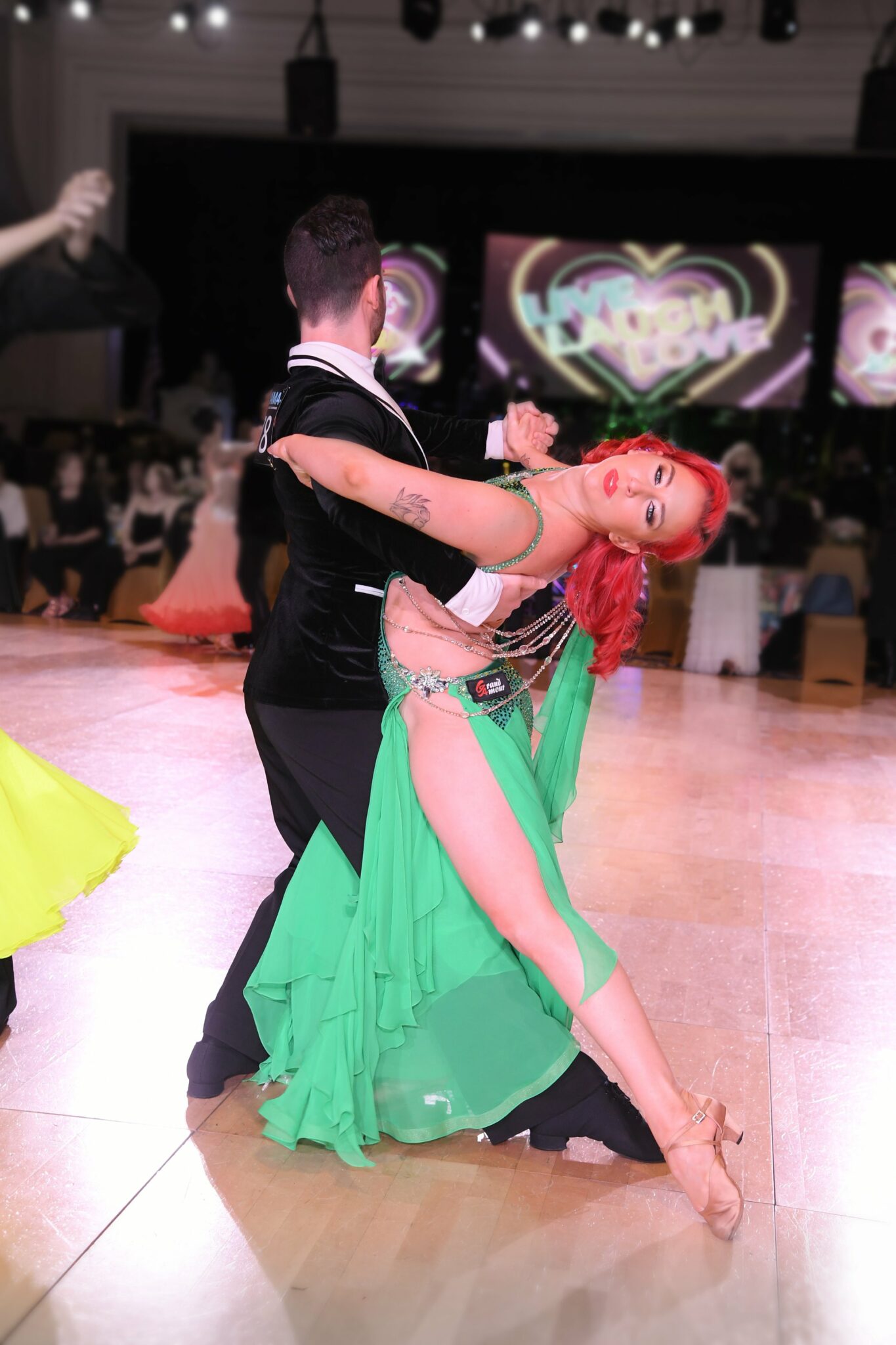 Fred Astaire Boise instructor Lisa Tice performing at a ballroom dance competition with her partner.