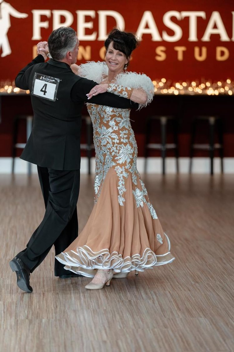 Art and Carol Laos dance together at Fred Astaire Boise, where they take ballroom dance classes as a way to bond and spend time together.
