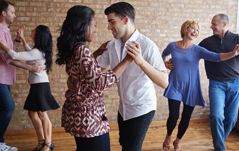 dancing couples in dance studio.