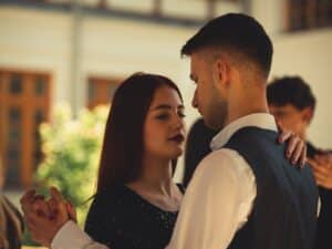 Young woman and man practicing the Waltz on a dance floor.