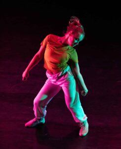 Woman in studio dancing solo.