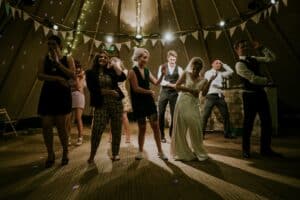 Wedding party performing a line dance at a wedding.