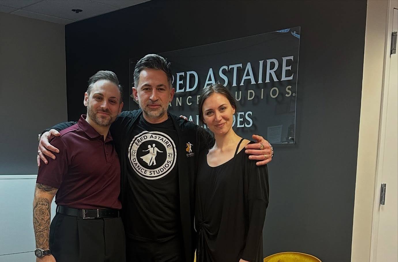 Dance instructors and students at Fred Astaire Dance Studios discussing the best Latin dance for beginners in Washington.