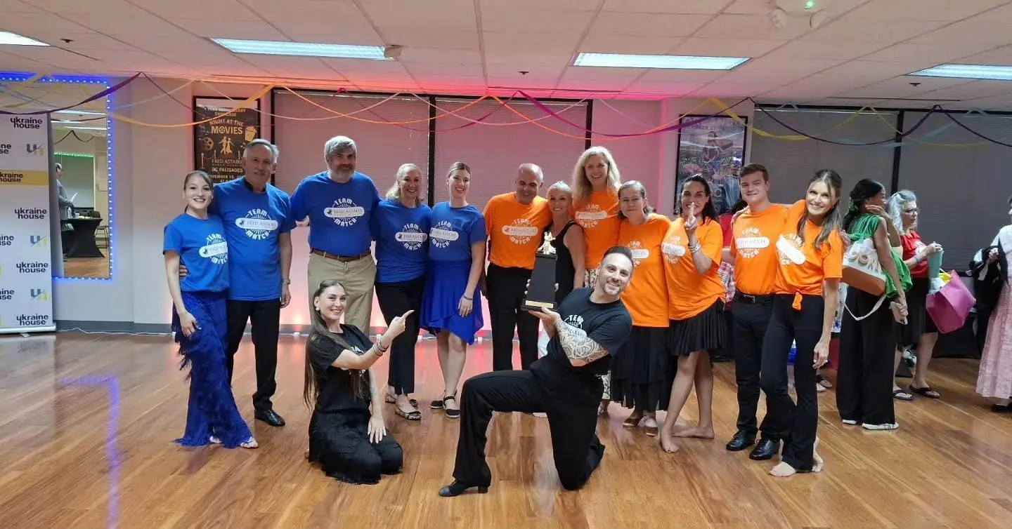 Group of adult students and instructors celebrating together after ballroom lessons during a Start Dancing in Washington event.