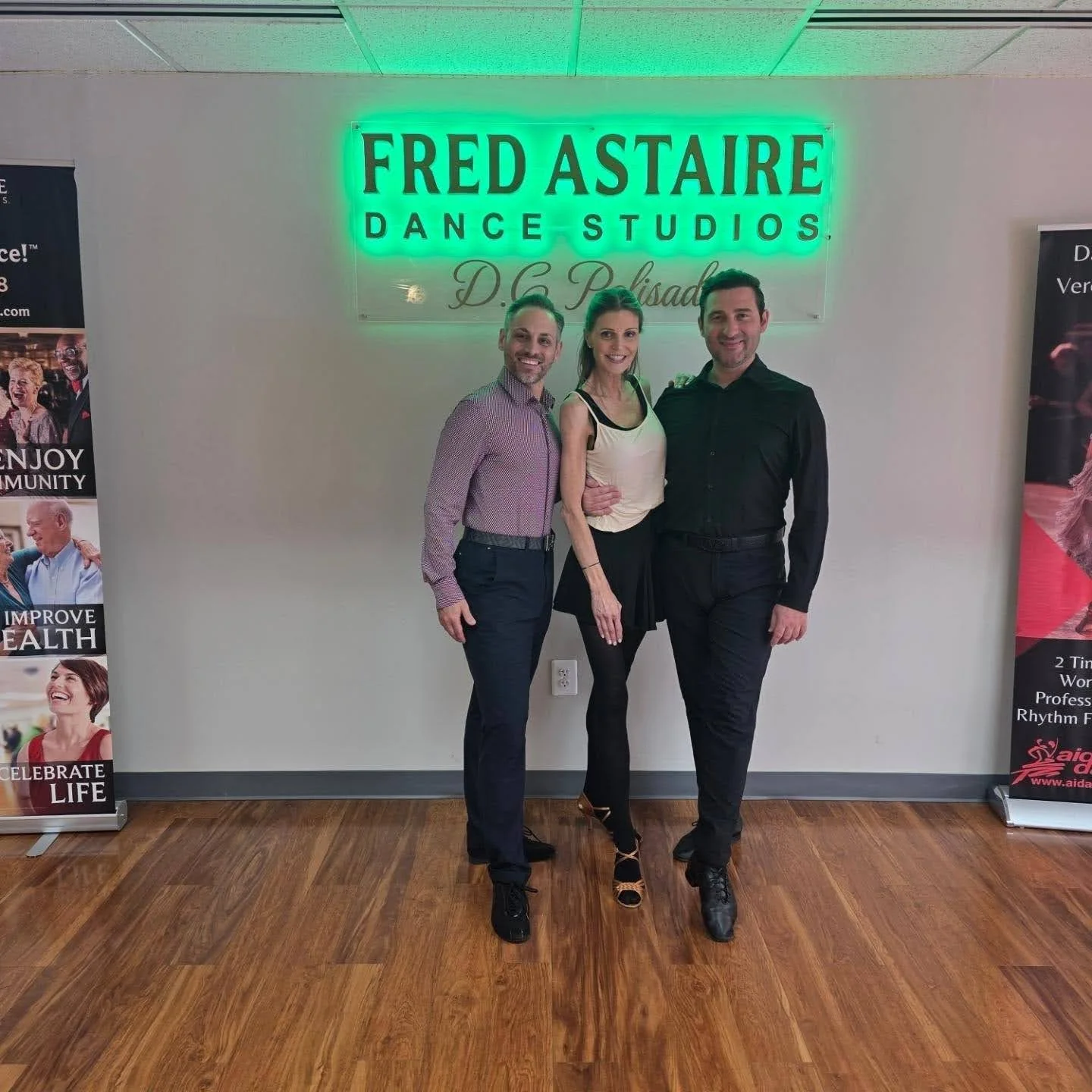 A dance beginner posing with her dance instructors just before her Ballroom Dance Lesson in Washington in a Fred Astaire Dance Studio Palisades DC.