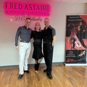 Three dancers pose inside Fred Astaire Dance Studios, highlighting a welcoming environment for Swing Dance for Total Beginners.