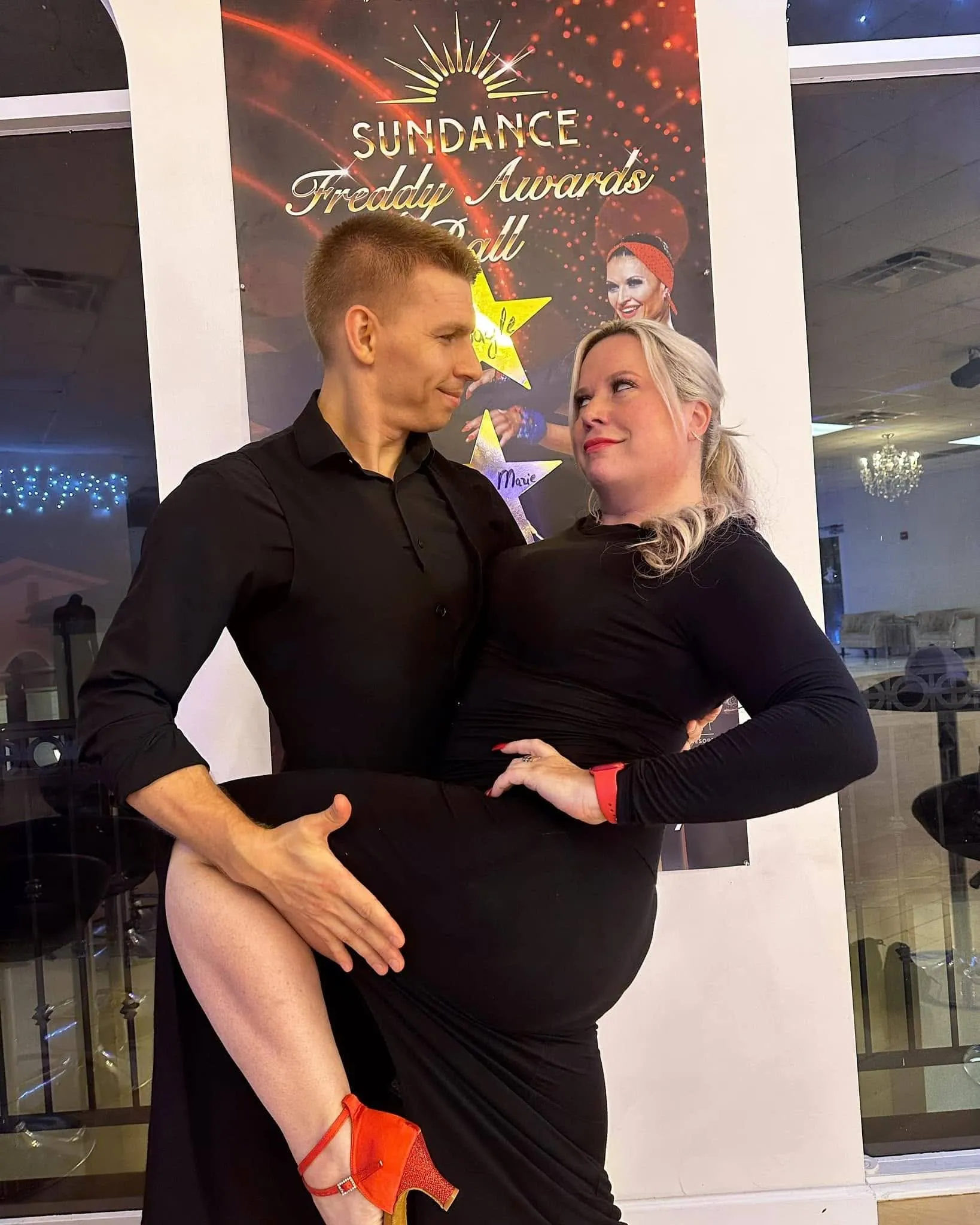 A couple posing in a ballroom dance hold at a dance studio, showcasing confidence and connection developed through Dance Lessons in Orlando FL.