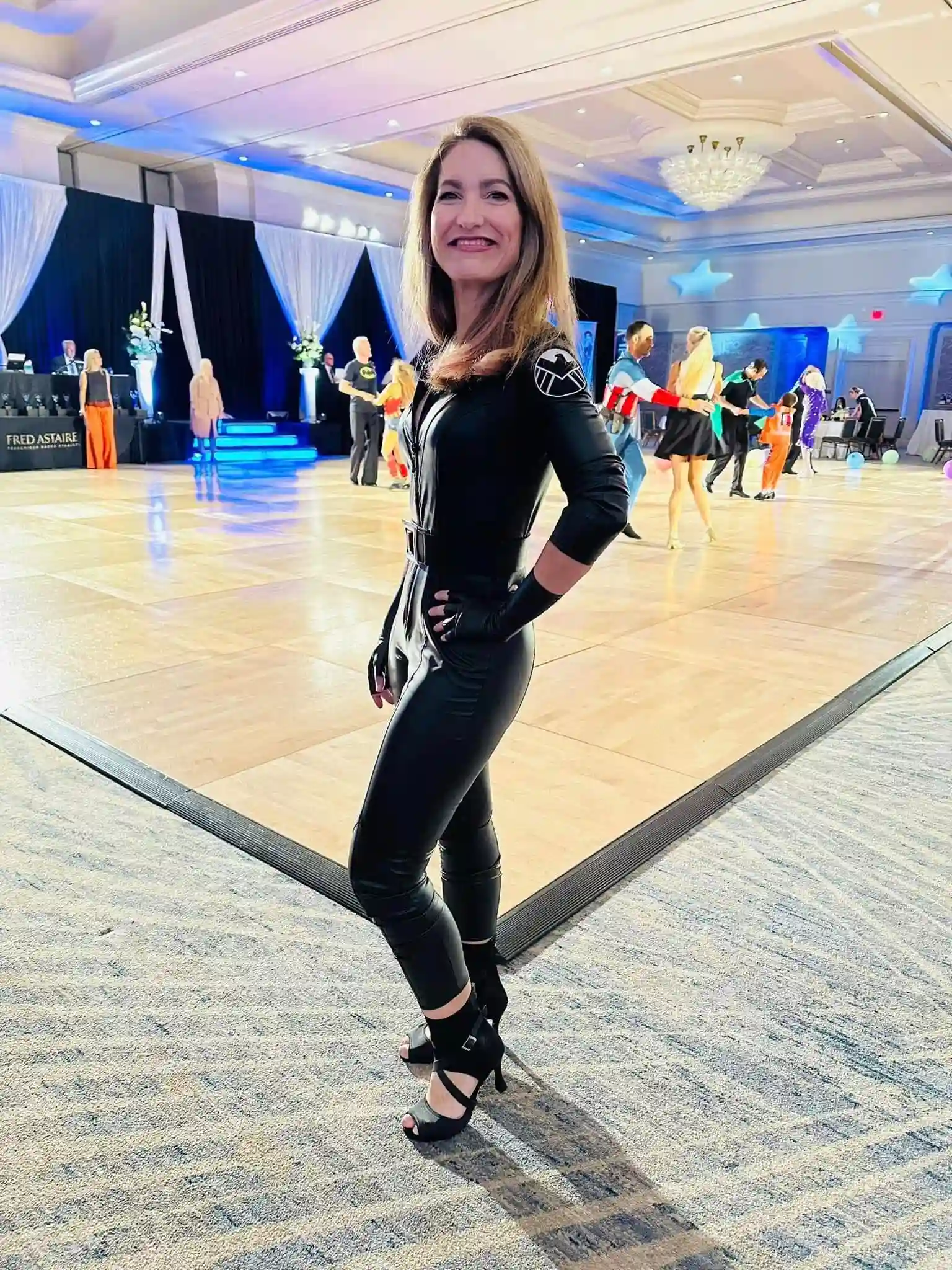 A woman striking a pose in a ballroom after completing her adult dance lessons in Orlando, FL.