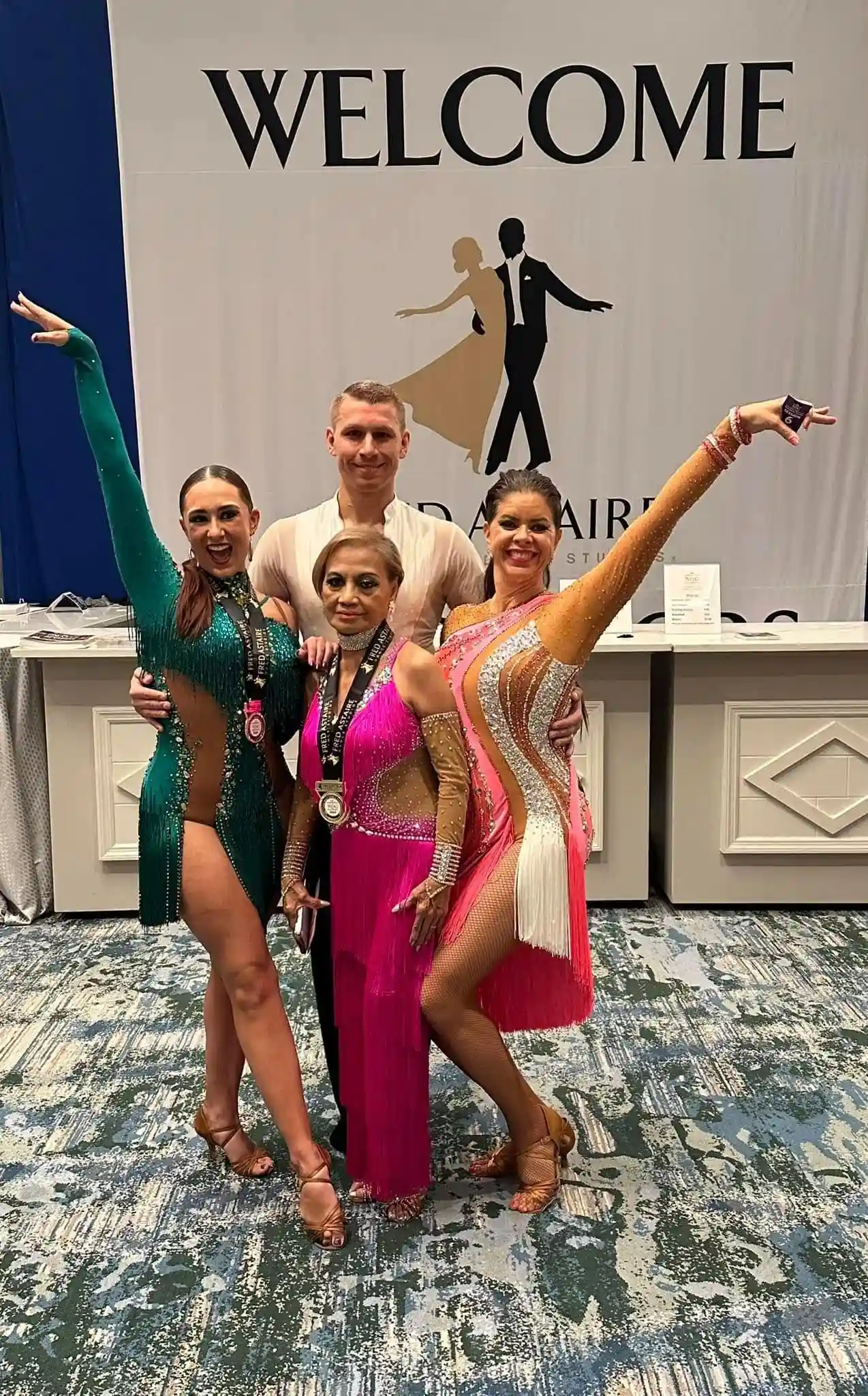 Dancers in their dancing outfits doing a pose after a dance competition. They have earned their place after acing the dance lessons in Orlando