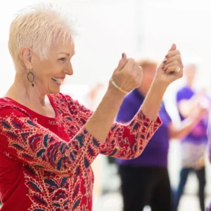 A middle aged woman takes swing dance lessons in Durham.