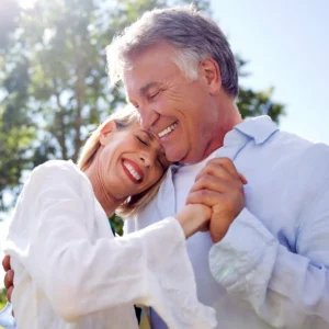 Man and wife take Waltz dance lessons.