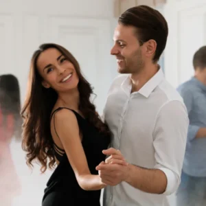 Instructor guiding a couple through their first dance lesson in Durham