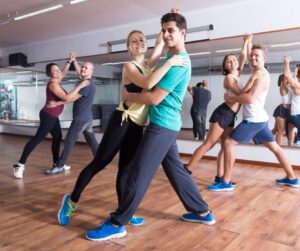 3 couples in a ballroom dance class