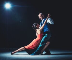 couple ballroom dancing while leaning on each other