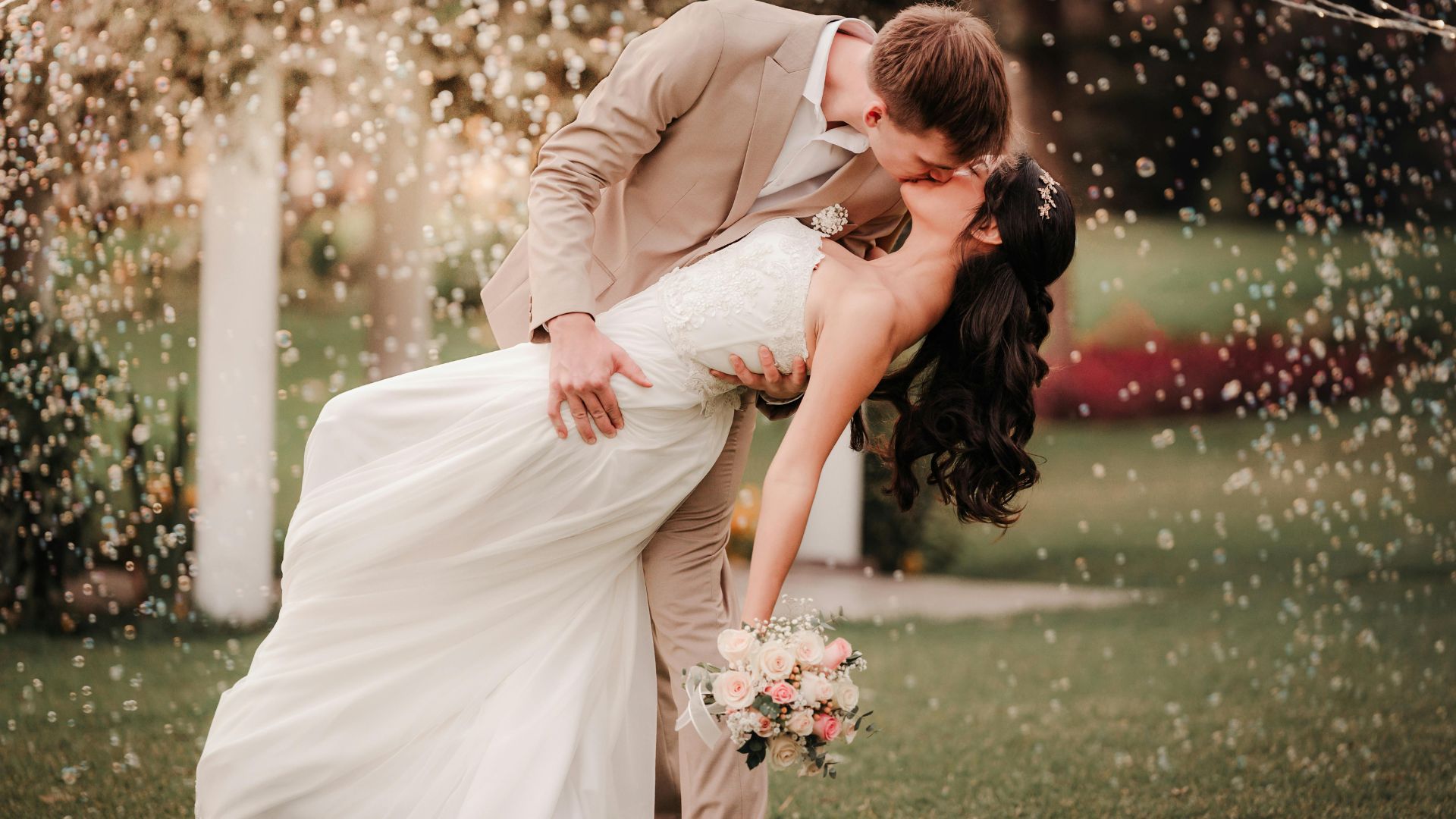 Bride and groom performing a romantic dip during their first dance, illustrating waltz dance lessons for weddings.