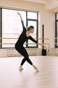 Young woman dancing in studio.