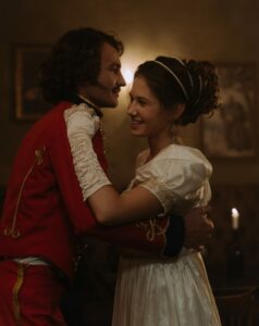 Couple wearing 17th century clothing and dancing the Waltz.