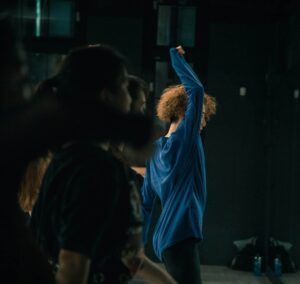 Group of people in a dance class, practicing.