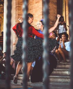 Two women dancing together outdoors.
