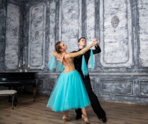 young couple ballroom dancing with a blue dress
