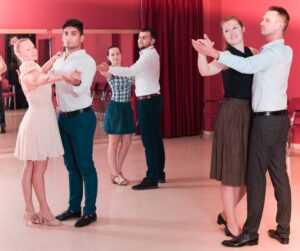 three couples in a ballroom dance class