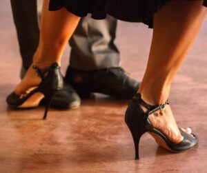 close up of couple dancing with black shoes