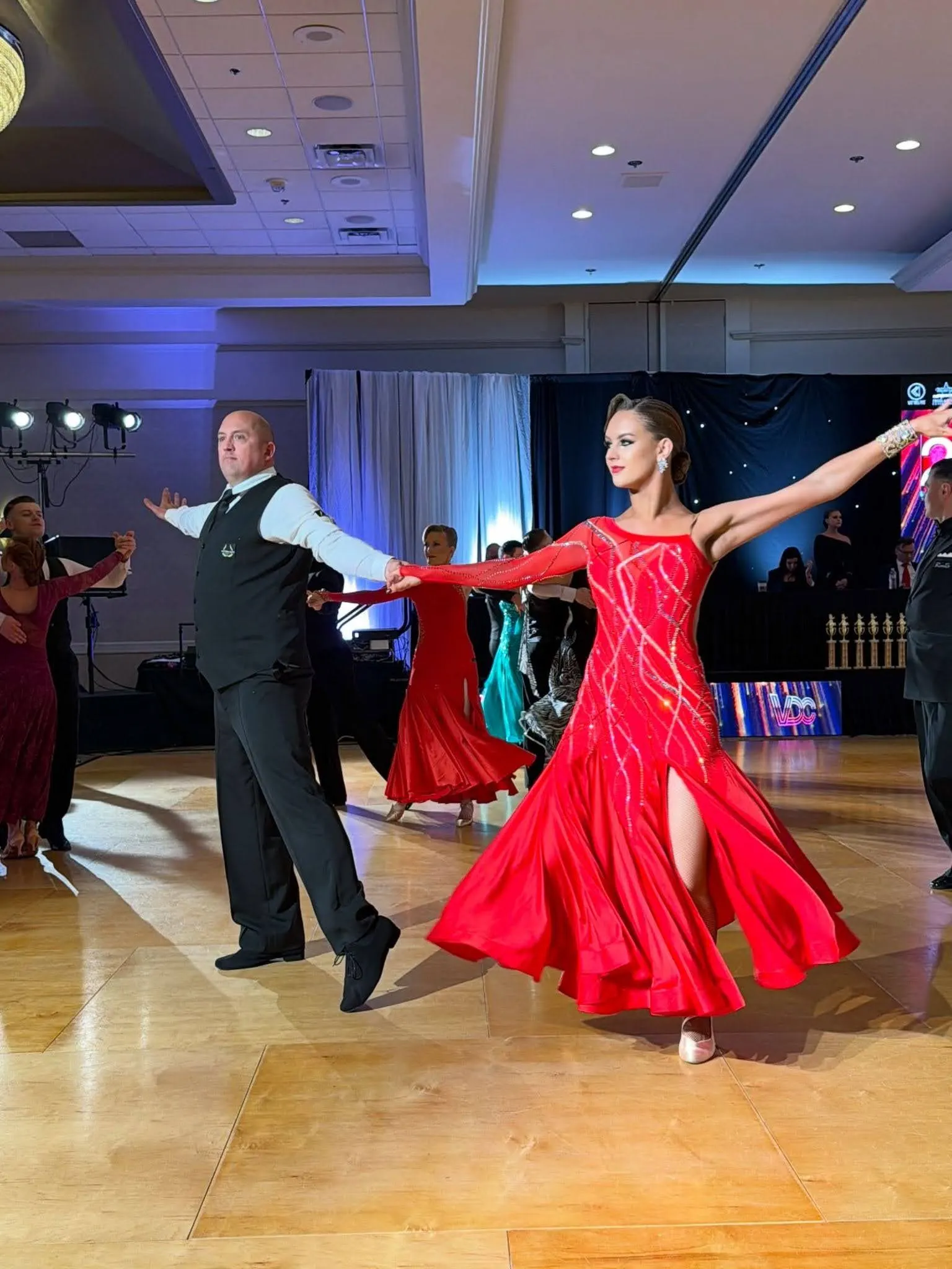Two solo students showing off their skill, flair and glamour after taking adult dance lessons in Morrisville.