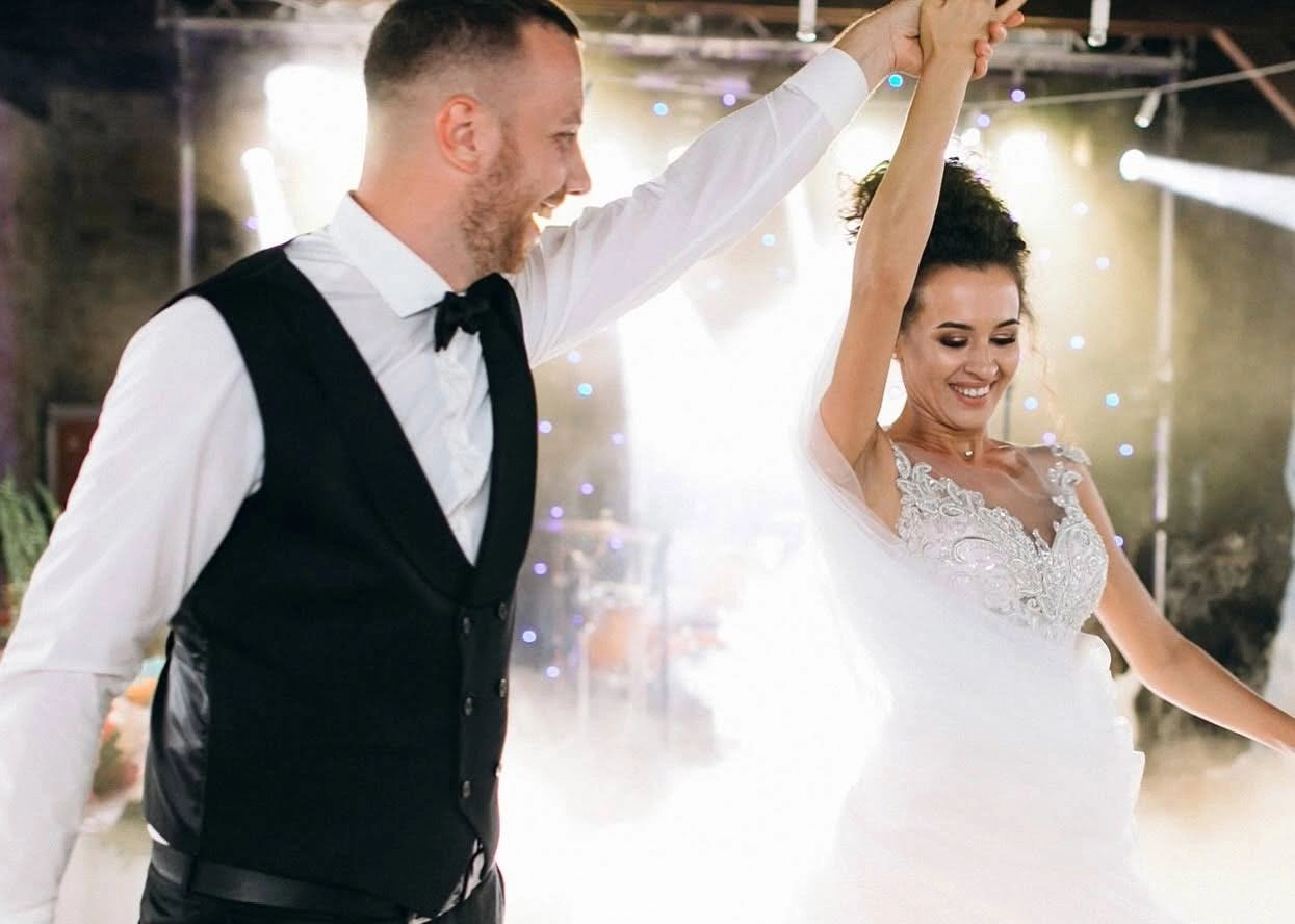 Bride and groom dancing together at their wedding reception, illustrating the Best Dance to Learn for a Wedding.