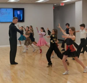 Children learning ballroom dance in a fun and supportive environment, building confidence, coordination, and social skills through Dance Lessons for Kids.