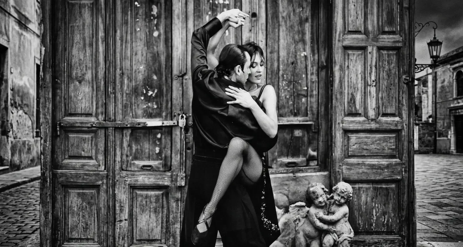Dancers performing an Argentine Tango leg hook in front of weathered wooden doors on a cobbled street